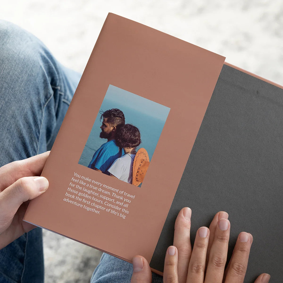 An open hardcover photo book with terracotta endpaper, small portrait, and printed dedication text on the right-hand page.