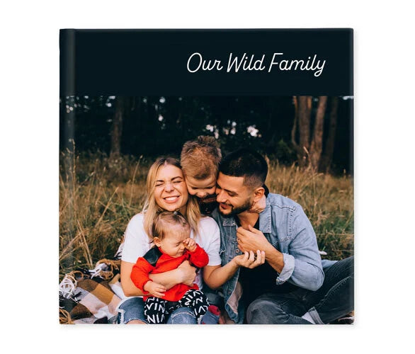 Hardcover photo book cover with candid outdoor family portrait and scripted title text on dark background.