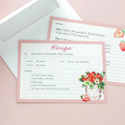 Flat recipe cards with pink borders and strawberry illustrations, featuring handwritten cookie recipe details on a pastel background with envelope.