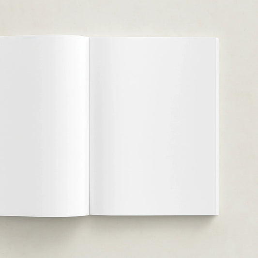 Open softcover photo book with blank pages on a light gray background