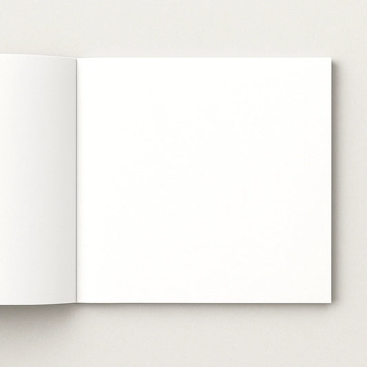Open softcover photo book with blank pages on a light gray background