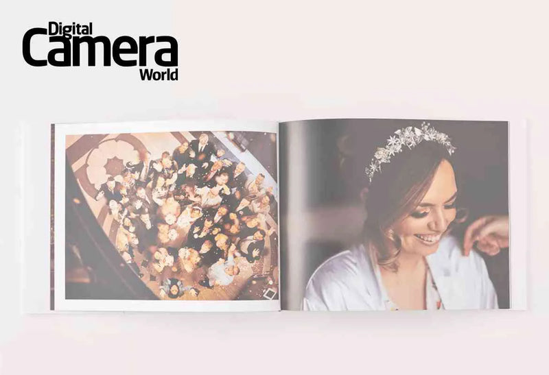 Open wedding photo book displaying an overhead group photo on the left page and a portrait of a smiling bride on the right, with Digital Camera World Logo.