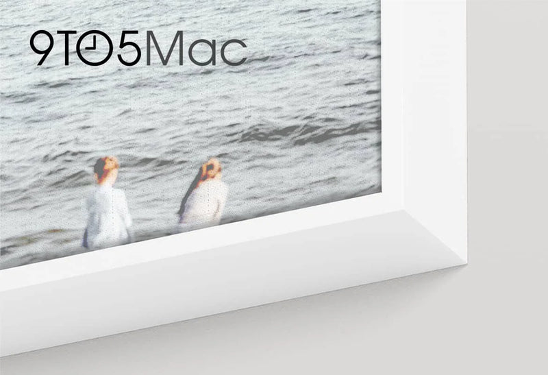 Close-up of a framed photograph with white matting featuring two people walking near the ocean, with the 9to5Mac logo visible.